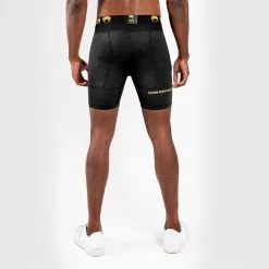 Venum G-Fit Compression Shorts, Black/Gold 13 Venum G-Fit Compression Shorts, Black/Gold -Udstyr og tilbehør butik VENUM 03725 126R Venum G Fit Compression Shorts Black Gold 04 0522